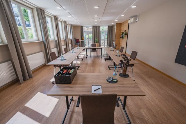 Tagungsraum mit langer Tafel und Fensterfront
